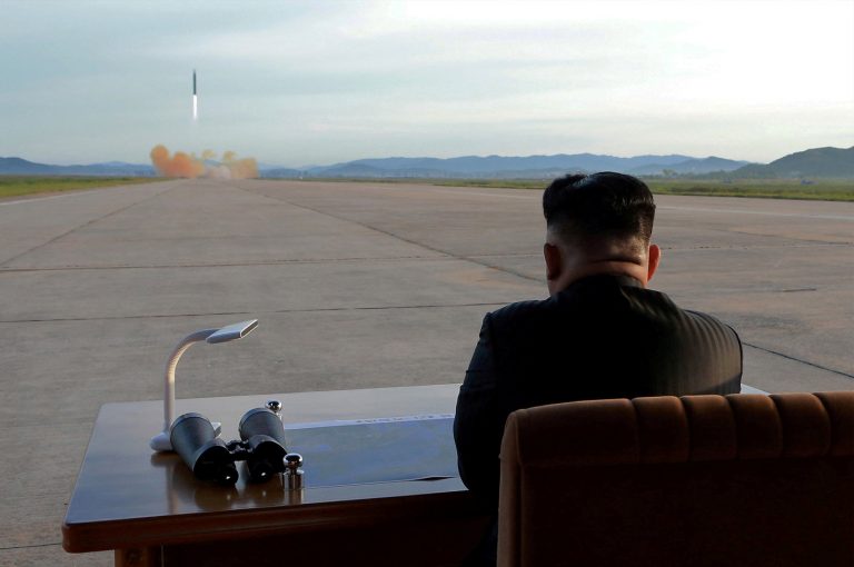 FILE PHOTO: North Korean leader Kim Jong Un watches the launch of a Hwasong-12 missile in this undated photo released by North Korea's KCNA