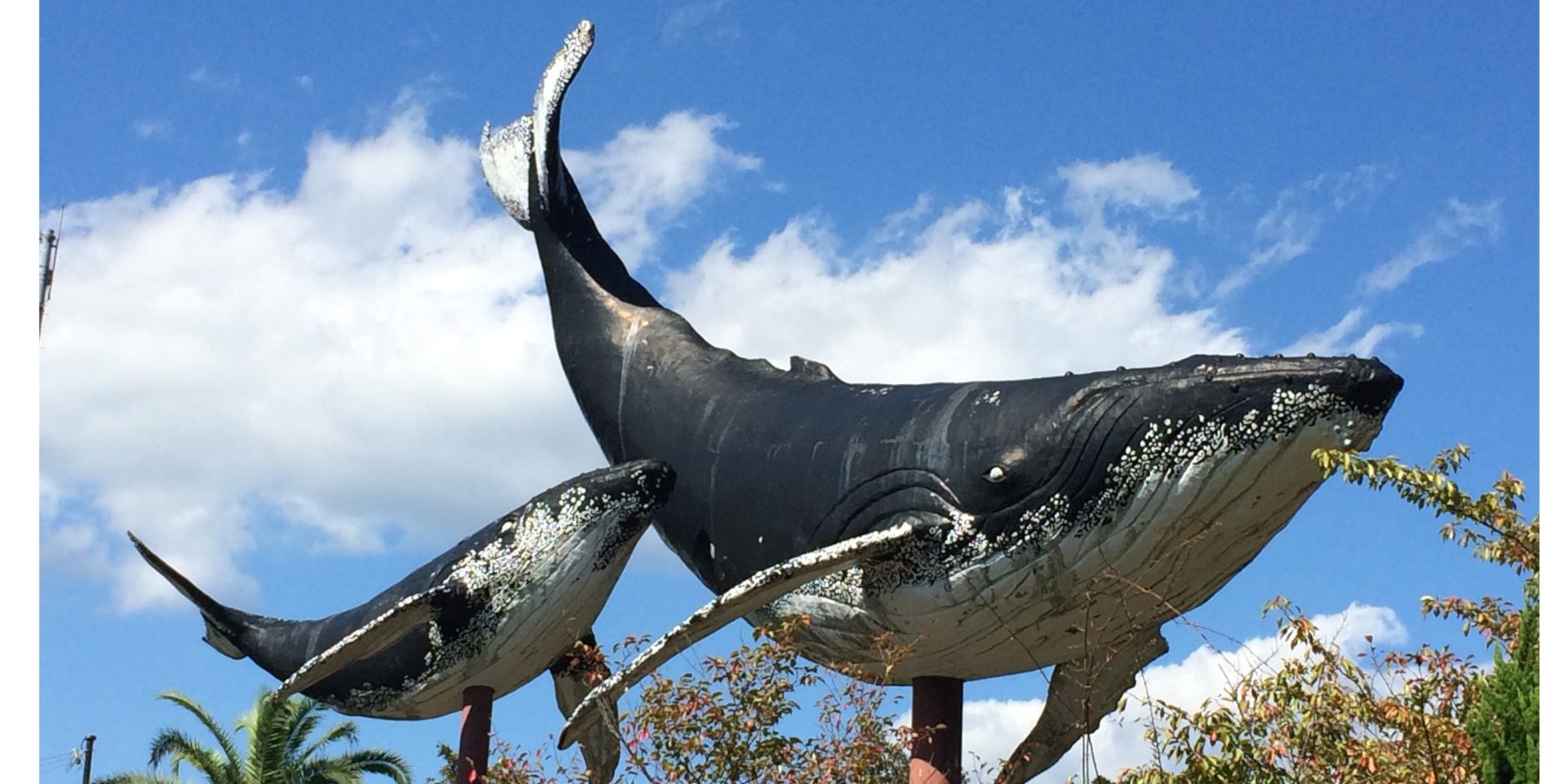 Outdoor statue of a humpback whale and calf
