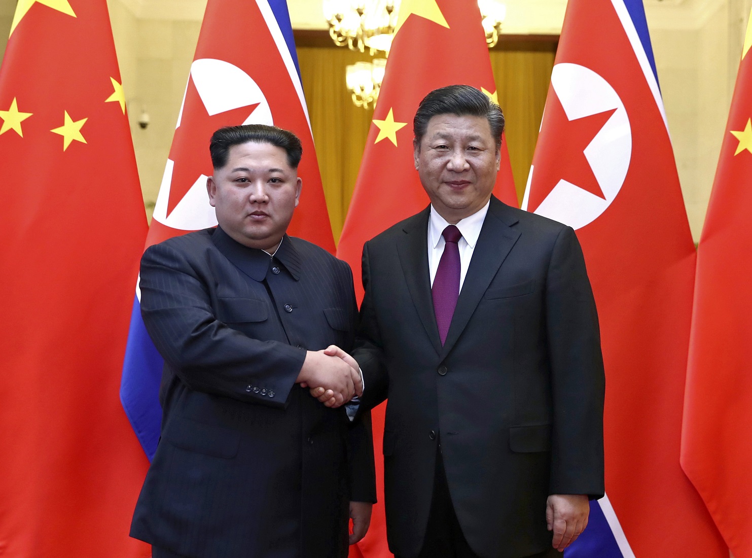 Xi Jingping right, and Kim Jong Un