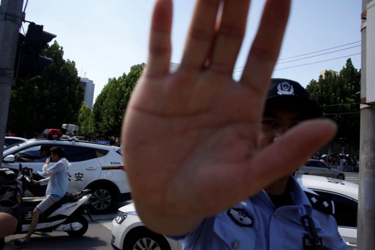 Police officer gestures near the U.S. embassy in Beijing