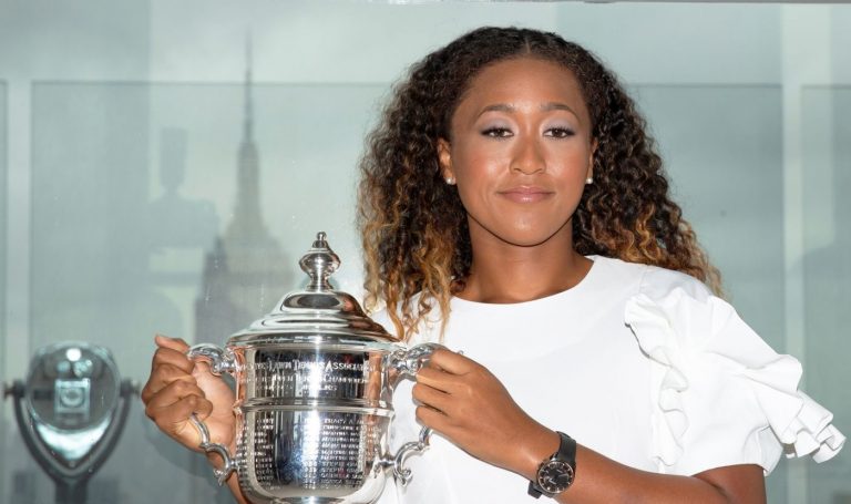 Naomi Osaka of Japan poses with the championship trophy at the Top of the Rock Observatory the day after winning the Women's Singles finals match against Serena Williams at the 2018 U.S. Open