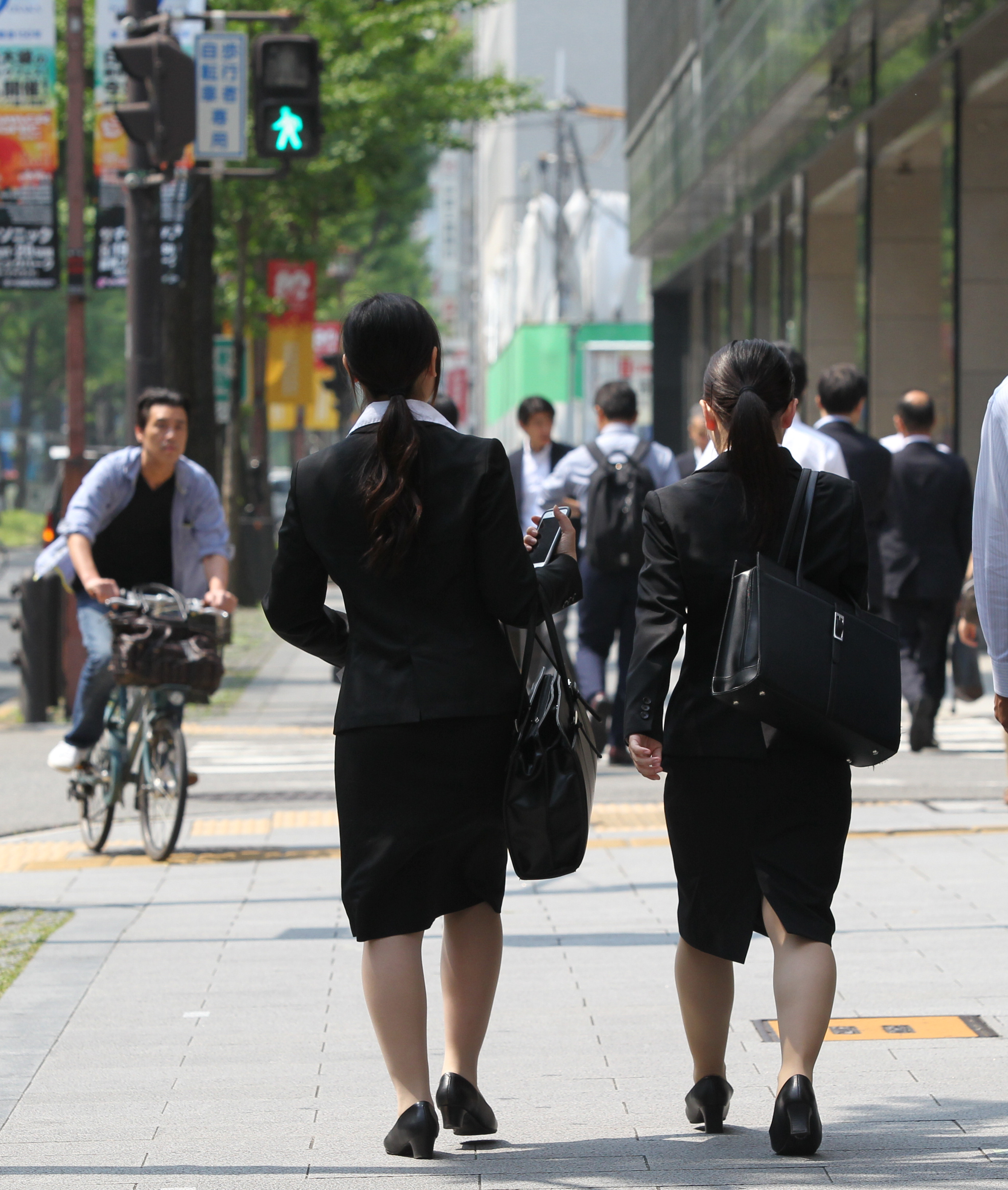 Women students wearing black suits