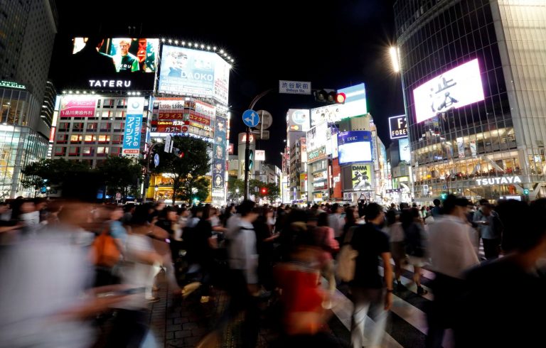 FILE PHOTO: Pedestrians walk at a scramble crossing at Shibuya shopping district in Tokyo