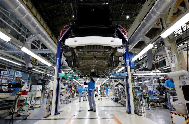 FILE PHOTO: Employees of Toyota Motor Corp. work on assembly line in Toyota