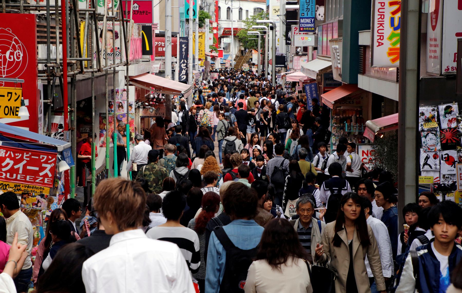 FILE PHOTO: People walk on a street in a busy shopping district in Tokyo