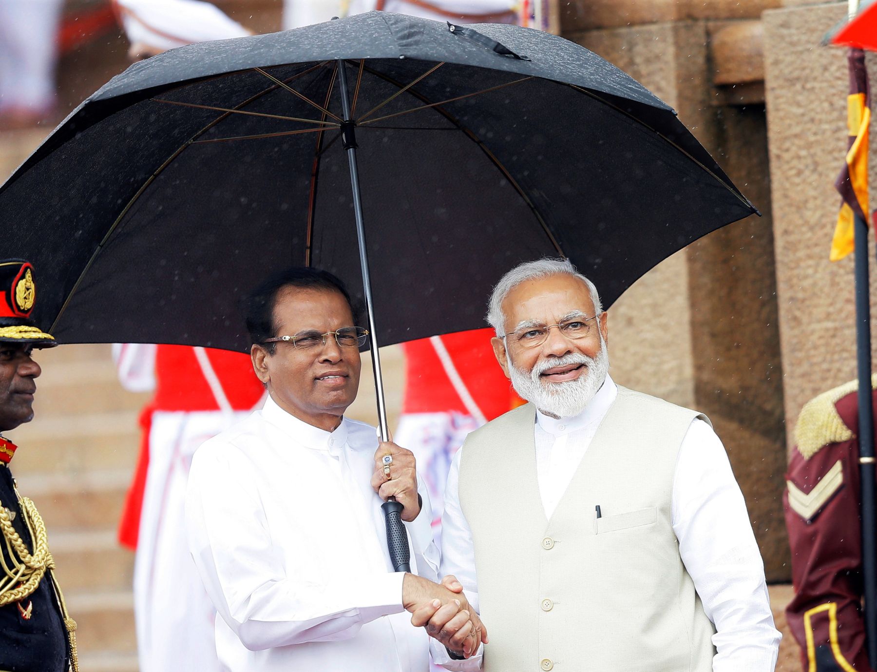 India's Prime Minister Narendra Modi shakes hands with Sri Lanka's  President Maithripala Sirisena during his welcome ceremony at the  Presidential Secretariat in Colombo