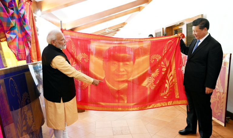 India's Prime Minister Narendra Modi and China's President Xi Jinping exchange gifts in Mamallapuram