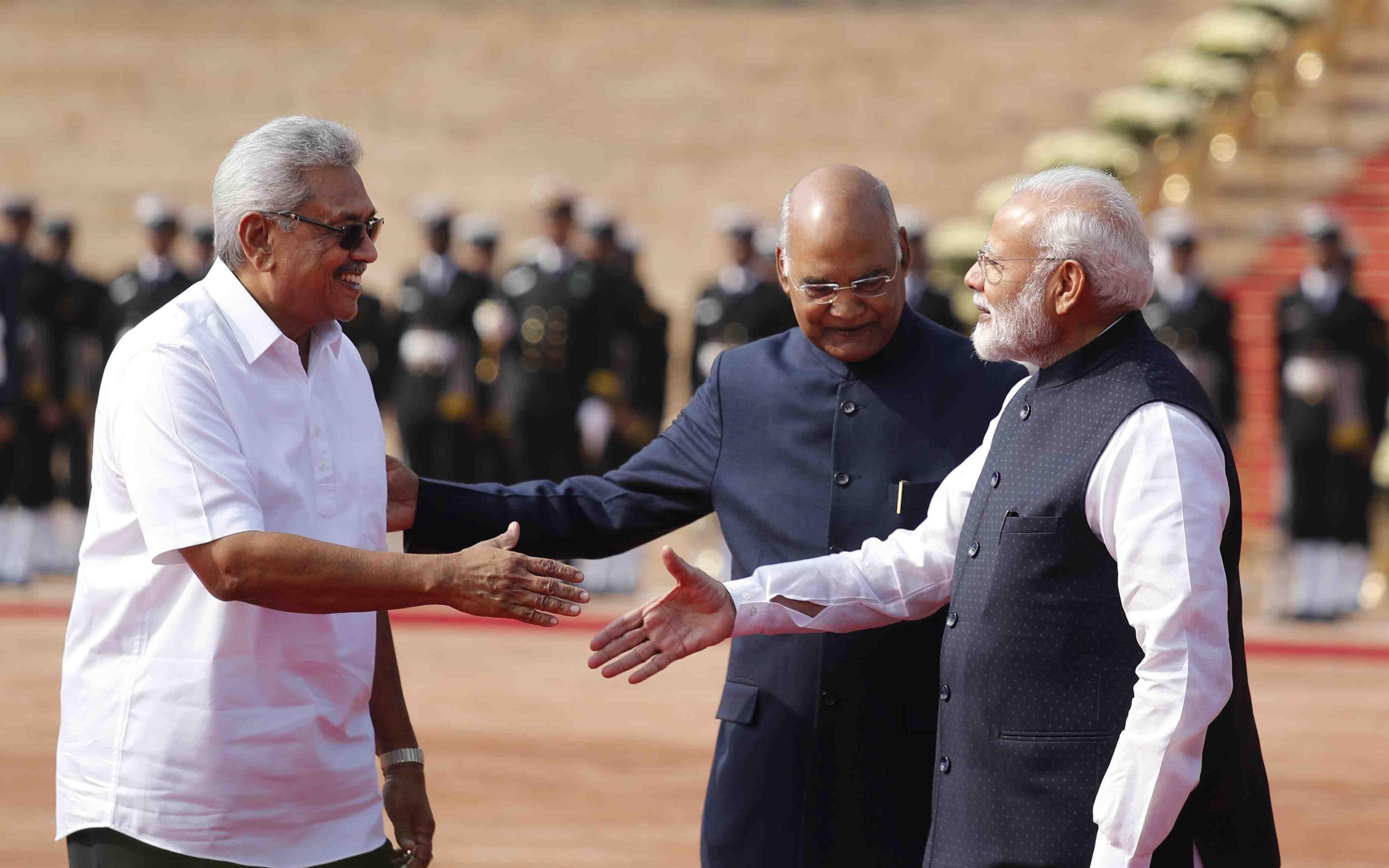 India's Prime Minister Narendra Modi shakes hands with Sri Lanka's  President Maithripala Sirisena during his welcome ceremony at the  Presidential Secretariat in Colombo