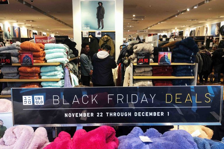 People shop at the Uniqlo store during the Black Friday sales event at Roosevelt Field Mall in Garden City, New York