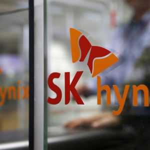 FILE PHOTO: Employee walks past the logo of SK Hynix at its headquarters in Seongnam