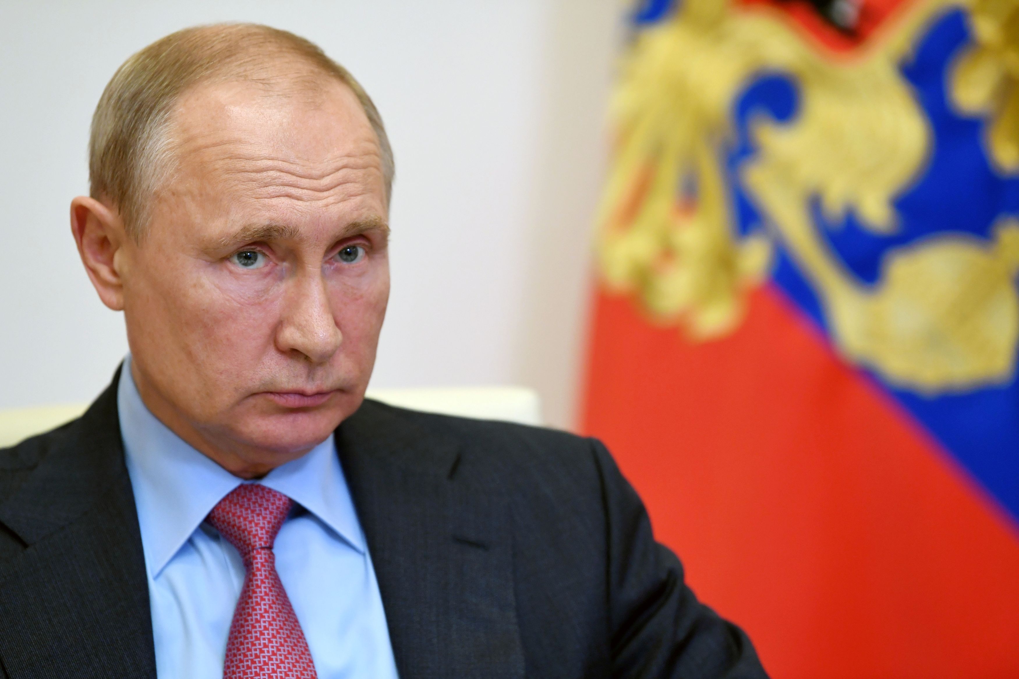 Russian President Vladimir Putin takes part in a video conference call outside Moscow