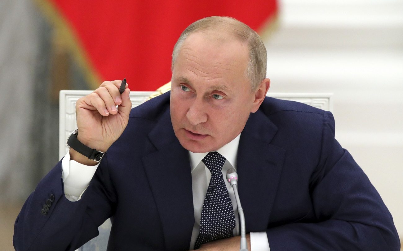 Russian President Vladimir Putin gestures while speaking during a meeting with employees of the nuclear industry on their professional holiday, Nuclear Industry Worker's Day, at the Kremlin in Moscow, Russia, Wednesday, Sept. 23, 2020. (Mikhail Metzel, Sputnik, Kremlin Pool Photo via AP)