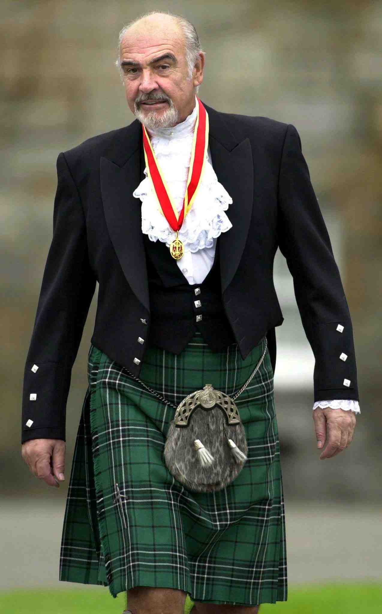 FILE PHOTO Sir Sean Connery wearing full highland dress walks towards