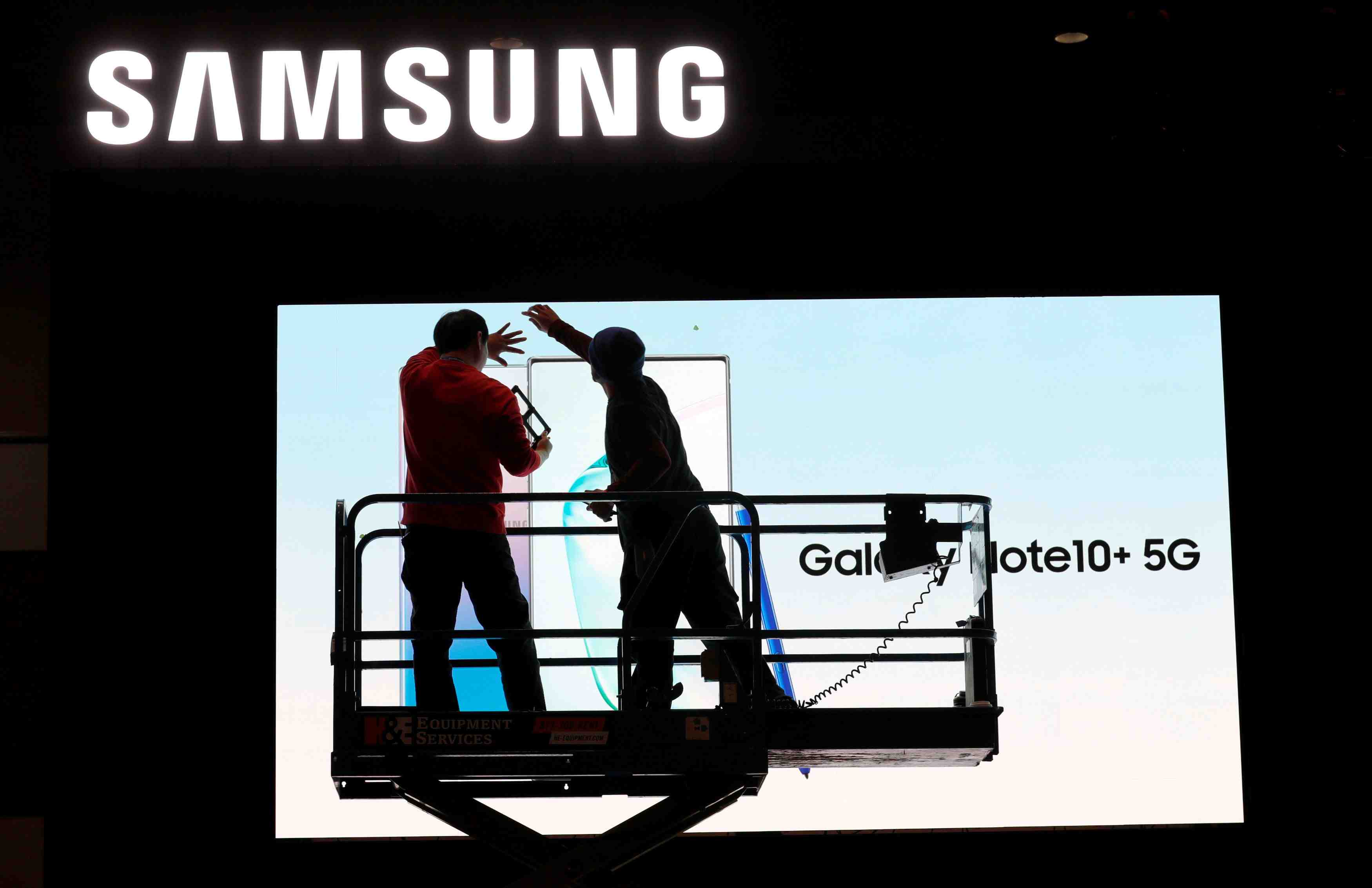 FILE PHOTO: Workers set up a Samsung display in the lobby of the Las Vegas Convention Center in preparation for the 2020 CES in Las Vegas