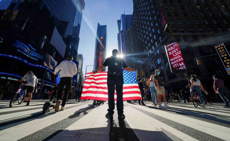 People celebrate after media announced that Democratic U.S. presidential nominee Joe Biden has won the 2020 U.S. presidential election, on Times Square in New York City