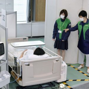 Tokyo Governor Yuriko Koike inspects an oxygen station for short-term stays