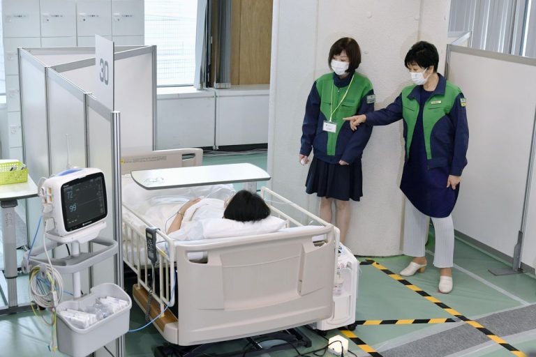 Tokyo Governor Yuriko Koike inspects an oxygen station for short-term stays