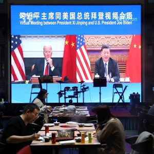 Screen shows Chinese President Xi Jinping attending a virtual meeting with U.S. President Joe Biden via video link, at a restaurant in Beijing