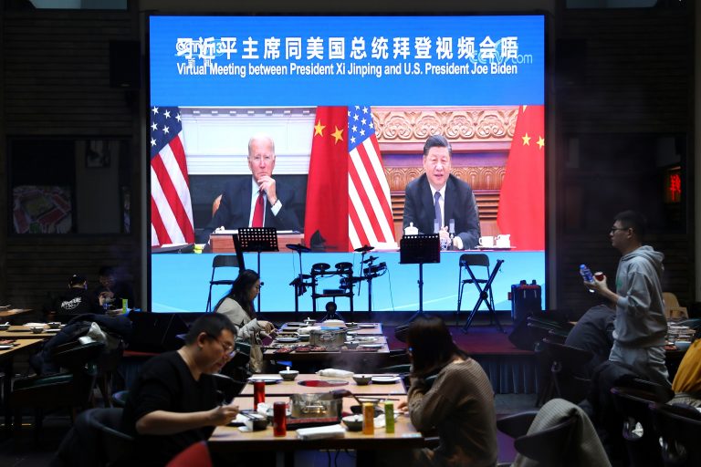 Screen shows Chinese President Xi Jinping attending a virtual meeting with U.S. President Joe Biden via video link, at a restaurant in Beijing