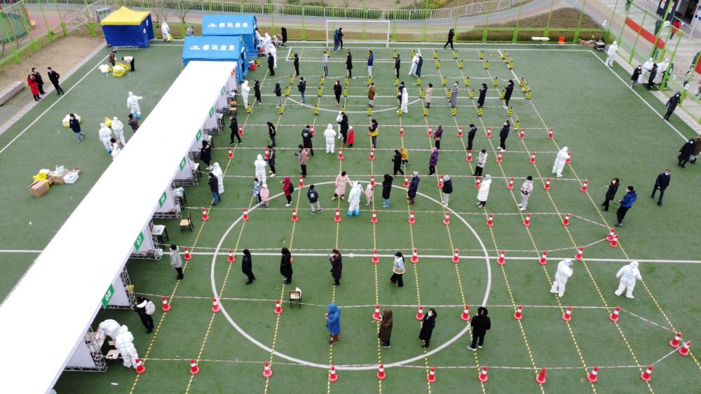 People line up during the second round of mass testing for COVID-19 in Tianjin