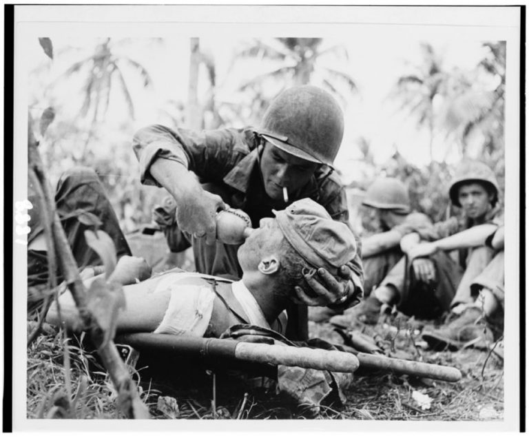 World War II Navy Corpsman Gives wounded Marine drink in battle on Guam 1944 R90