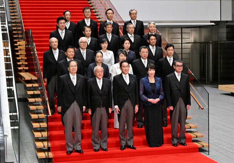 Japanese Prime Minister Fumio Kishida poses with his new cabinet at his official residence in Tokyo